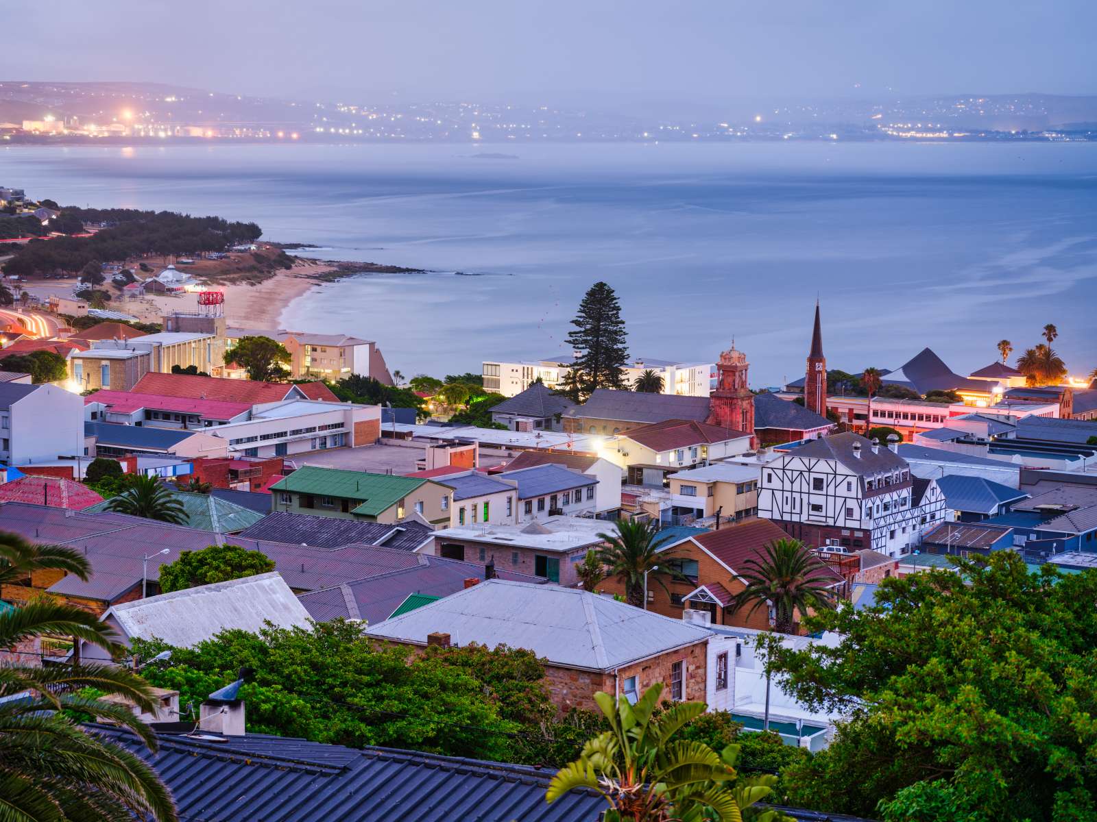 Mossel Bay mit Kirchturm am Abend, dahinter die Bucht